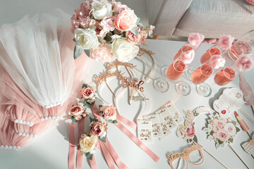 
The decor of glasses, hoops, plates, bands, veils and stickers in the style of the bride's bachelorette party.