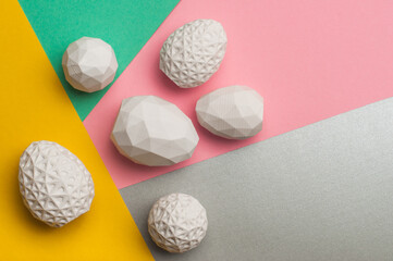 Easter eggs with geometric patterns on color blocks yellow, green and pink background