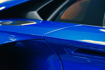 close-up of a blue sports car door handle