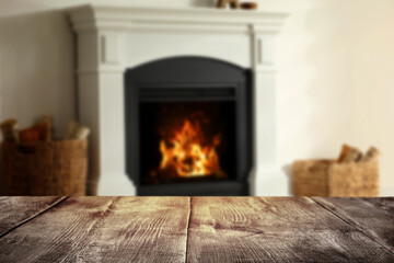 Empty wooden surface and blurred view of fireplace in room