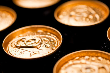 Studio photo of wet golden beer cans.