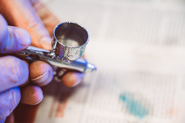 Man painting with airbrushing a work of art