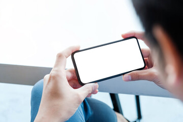 Top view man sitting and holding blank screen mock up mobile phone