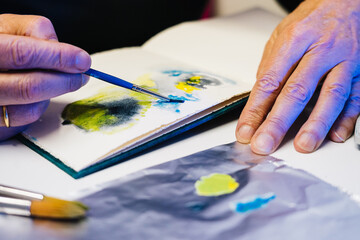 Man painting with airbrushing a work of art