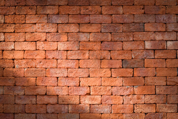 Red brick wall with shining light for background.