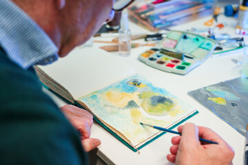 Man painting with airbrushing a work of art