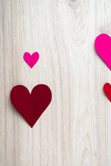 Plakat Cutted and folded paper Red hearts on a bright wooden Background. Card for Valentine's Day.