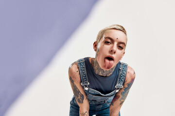 Tattoo and piercing. A close up of a white woman having piercing and tattoos looking into a camera...