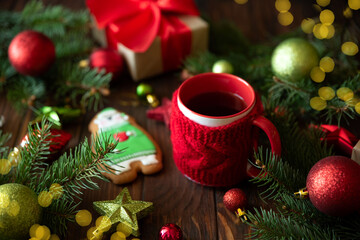 Hot Christmas tea with gingerbread cookie on wooden table. Top view. New Year and Christmas celebration concept. Top view