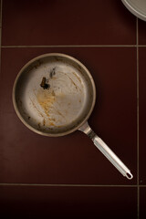 Dirty pan with extinguished cigarette.