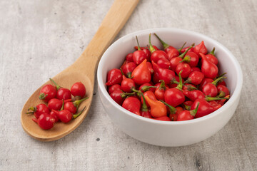Red pepper pout on a bowl and spoon over wooden table