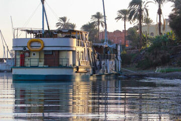 Fototapeta na wymiar Traditional tourist boats on the Nile, Egypt. Reflection in water