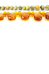 Two necklace made of natural Baltic amber isolated on a white background. Copy space for your text.