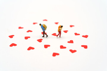 Miniature people standing with Heart shaped red paper. Red heart is the promise of love.  as background Valentine concept with copy spaces for your text or design.