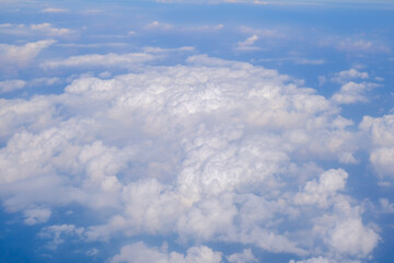 Fototapeta premium Blue sky background with tiny clouds from airplane