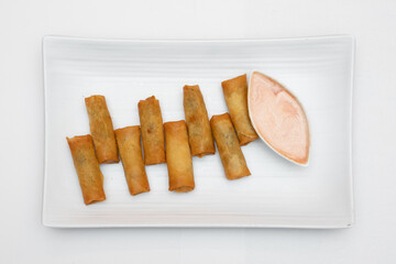 Chicken nuggets on plate with sauce.