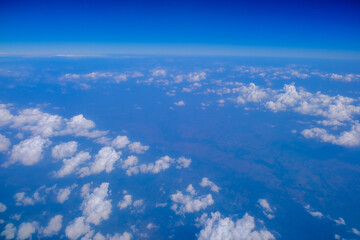 Fototapeta na wymiar Blue sky background with tiny clouds from airplane