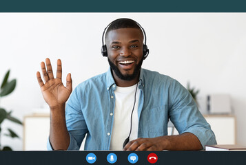 Videocall screenshot of happy young black man in headset having web conference