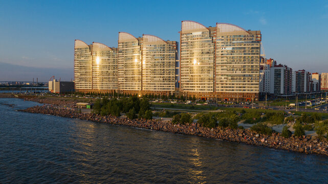 Saint-Petersburg. The beach near the new buildings of the Parusa residential complex. People relax on the beach.