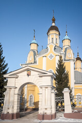Fototapeta na wymiar Golden domes of a christian temple against the blue sky in winter