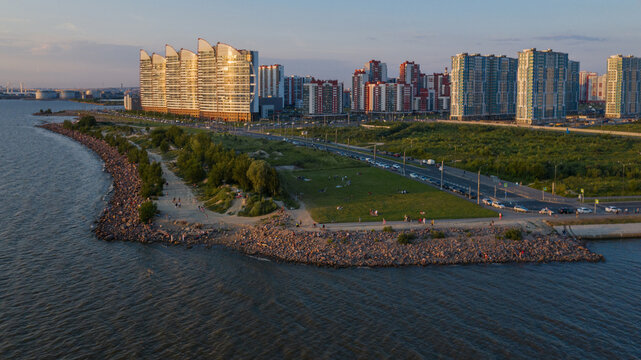 Saint-Petersburg. The beach near the new buildings of the Parusa residential complex. People relax on the beach.