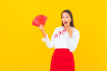 Portrait beautiful young asian woman with red envelopes letter