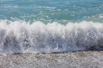 Fototapeta premium Blue sea water waves with white foam and bubbles. Winter see. Riva Trigoso on ligurian coast