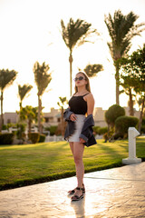 Fashion nice beautiful young woman, teenage girl walk in vacation. happiness and nice body for enjoyed people live an alternative lifestyle as vacation. Close up portrait on palm background.