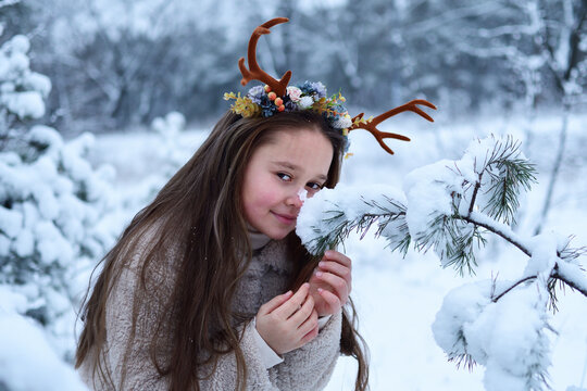 fairy girl with deer horns in winterforest. Beautiful mystery woman. Christmas snow fairy tale.characters of the fairy forest