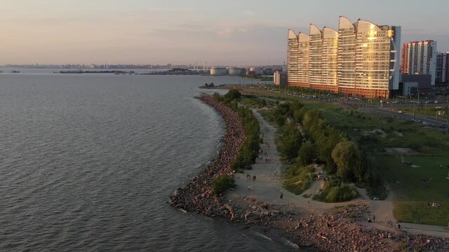 Saint-Petersburg. The beach near the new buildings of the Parusa residential complex. People relax on the beach.