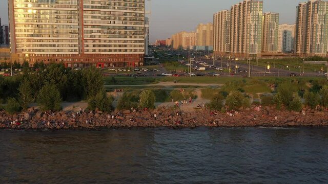 Saint-Petersburg. The beach near the new buildings of the Parusa residential complex. People relax on the beach.