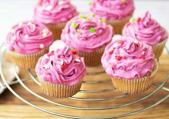  festive muffin with bright cream. cupcake decorated with decor and cream, top view. mini cake, pastries on a wooden background. cookie bar. High quality photo