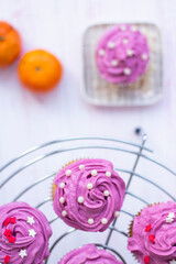  festive muffin with bright cream. cupcake decorated with decor and cream, top view. mini cake, pastries on a wooden background. cookie bar. High quality photo