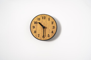 Fototapeta na wymiar wood office wall clock with white dial on white background. wall clock on white background, top view.