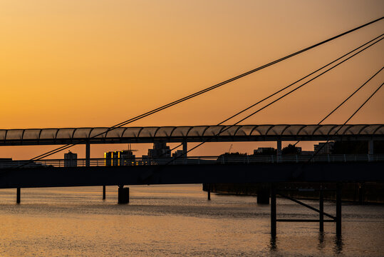 Sunset Reflected on the River Clyde in Glasgow Scotland With Bridge Silhouetted in Foreground