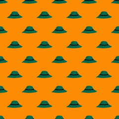 Summer hat seamless pattern with doodle green panama ornament. Bright orange background.