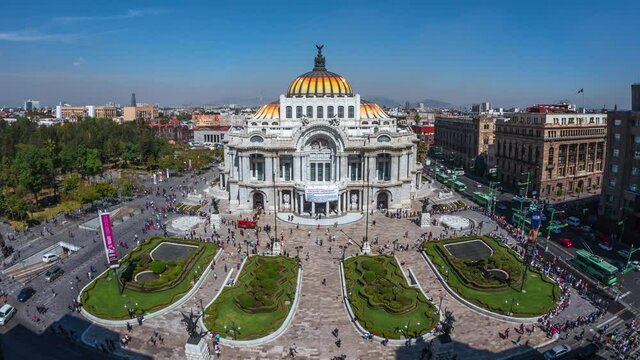 Zoom out time lapse view of people and traffic around the Palace of Fine Arts (Spanish: Palacio de Bellas Artes ) in the Historic Center of Mexico City, Mexico.