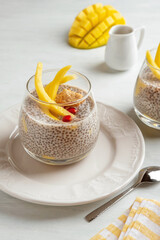 Vegan chia coconut pudding with mango on white background. Healthy nutrition, superfood. Closeup view.