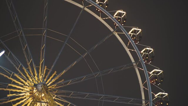 Ferris wheel at night in an amusement park. No people due to quarantine in Odessa amusement park