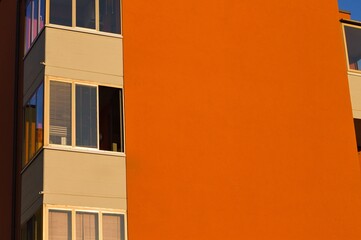 An orange building with window glasses in the corner (Pesaro, Italy, Europe)