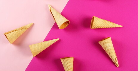 Emty Ice cream cones pattern on pink background. Top view. Several wafer ice cream cones designe