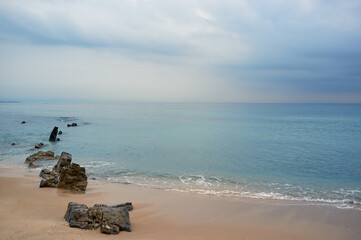 Natural minimalist seascape. Sand beach with cloudy sky before storm. Tarifa, Cadiz, Andalusia, Spain.