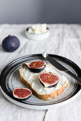 Sandwich with Ricotta and fresh Figs on natural linen tablecloth. Simple healthy breakfast