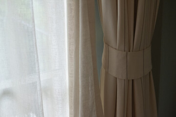 Close up of brown curtain, light spot from window curtain