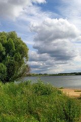 Landscape with the Volkhov River. There are spectacular cumulus clouds in the sky.