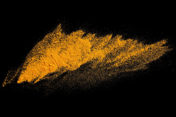 Isolated splashes of turmeric on a black background. Explosion. Seasoning. The powder of the turmeric root. The taste of curry. India. Element for the design. Volatile yellow powder.