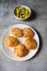 Top view of  Indian delicacy puri or fried flour and masala potato in a bowl.