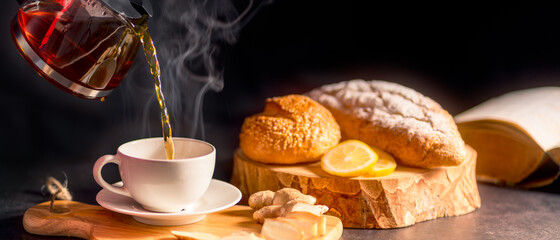 Hot drink of ginger tea in white cup with water vapor. Panoramic banner of Organic Herbal Drink with copy space