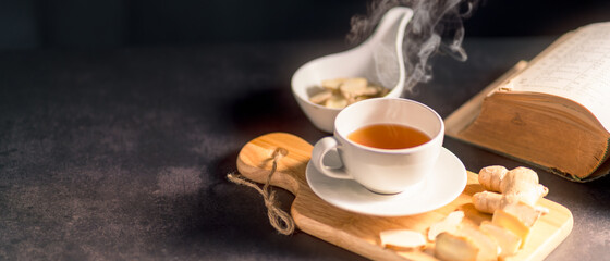 Hot drink of ginger tea in white cup with water vapor. Panoramic banner of Organic Herbal Drink with copy space