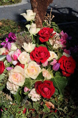 Gesteck kreativ mit Baumrinde und Blumen  nach Beerdigung auf dem Friedhof